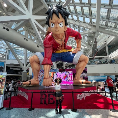 Ajani Russell posing under the One Piece Luffy's Idol. 